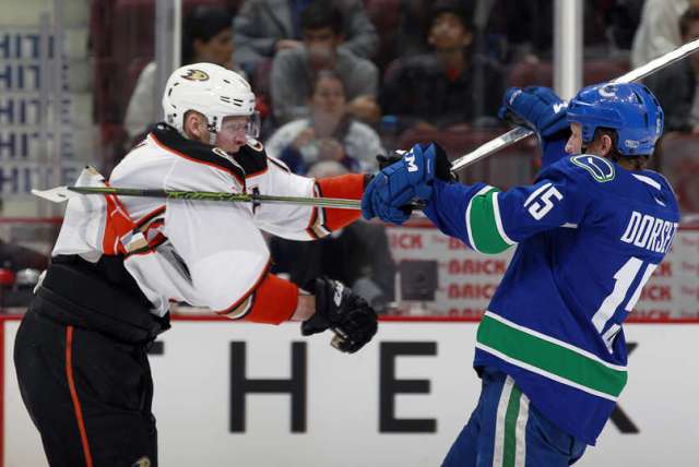 VANCOUVER, BC - FEBRUARY 18: Corey Perry #10 of the Anaheim Ducks and Derek Dorsett #15 of the Vancouver Canucks spar during their NHL game at Rogers Arena February 18, 2016 in Vancouver, British Columbia, Canada. Anaheim won 5-2. (Photo by Jeff Vinnick/NHLI via Getty Images)