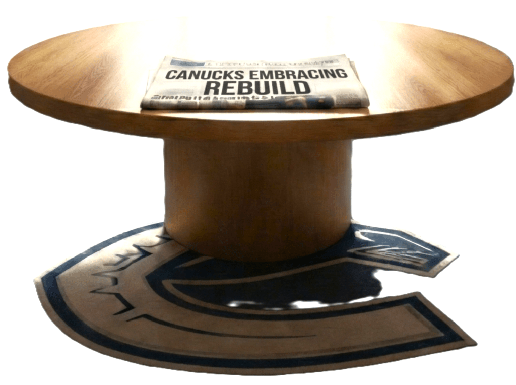 A round wooden table with a newspaper titled 'CANUCKS EMBRACING REBUILD' resting on top. The table is placed on a floor mat featuring the Vancouver Canucks logo.